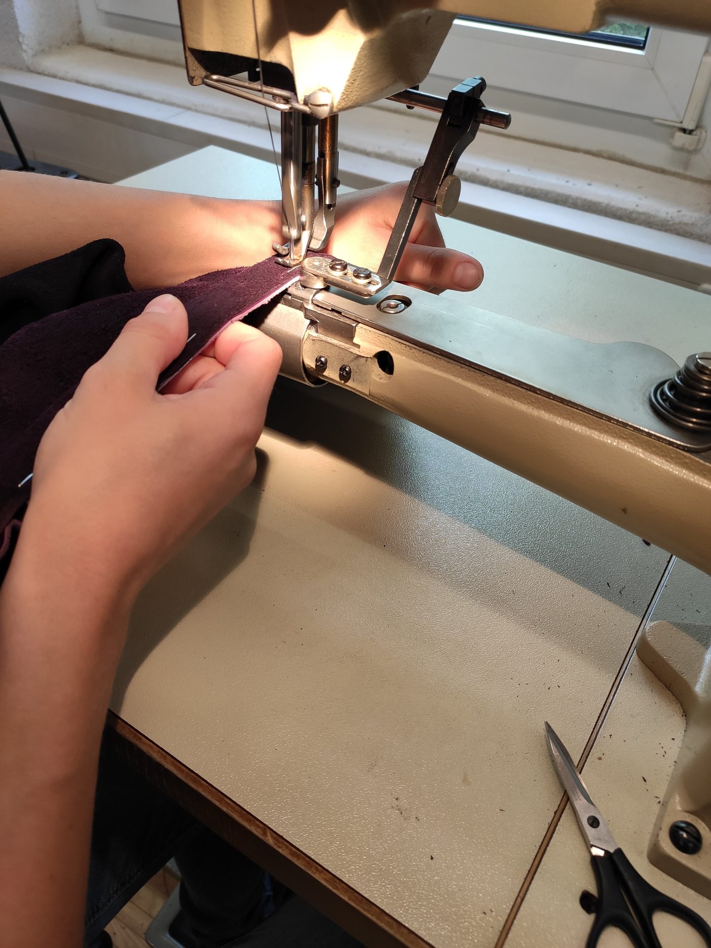 Näharbeit am Bezugsstoff der Sitzbänke an der Industrienähmaschine